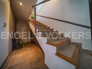 This stunning property boasts a beautiful tiled staircase with wooden accents, adding a touch of elegance to the home.