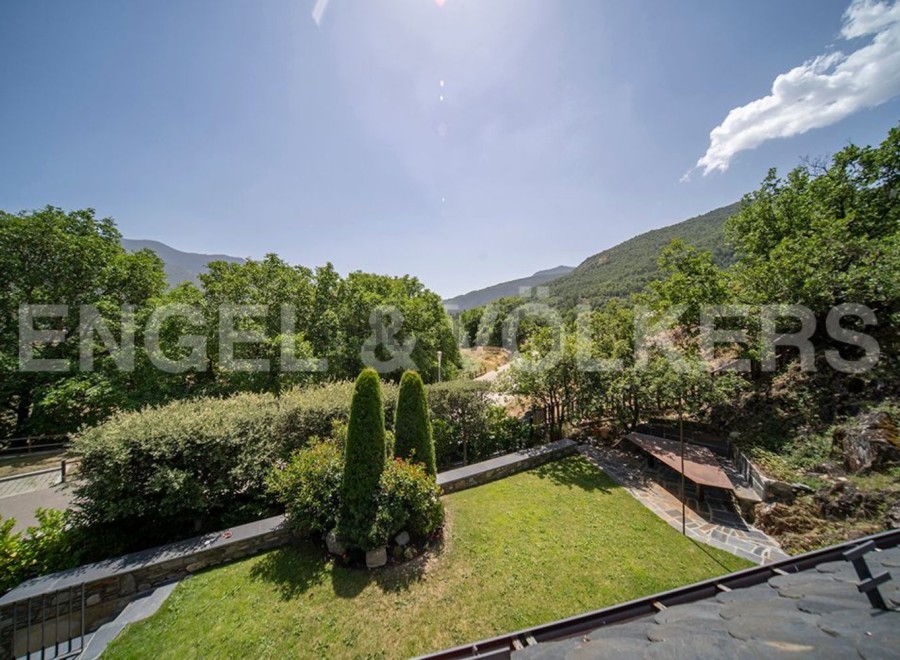 Mountain views and a private garden highlight this stunning property.
