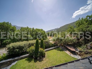 Mountain views and a private garden highlight this stunning property.