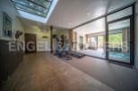 This stunning property boasts a state-of-the-art home gym, complete with a treadmill and elliptical, perfect for maintaining a healthy lifestyle.