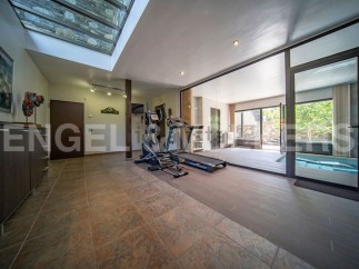 This stunning property boasts a state-of-the-art home gym, complete with a treadmill and elliptical, perfect for maintaining a healthy lifestyle.