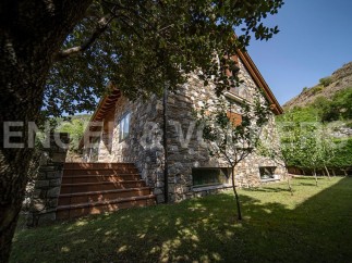 This stunning stone house boasts a picturesque setting, nestled amongst lush greenery and offering breathtaking views.