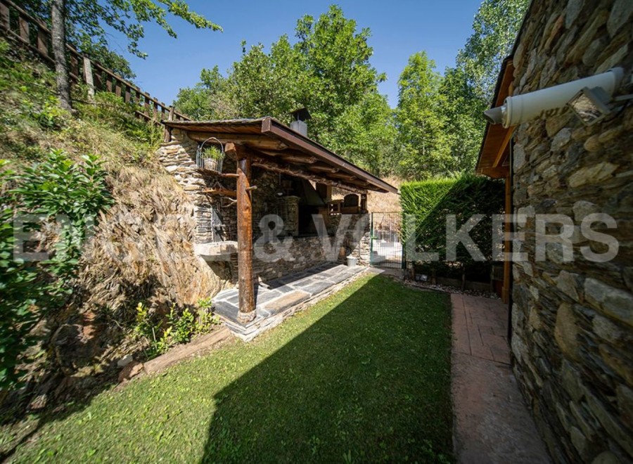 This charming property boasts a rustic stone outdoor kitchen and barbecue area, perfect for al fresco dining and entertaining.