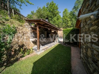 This charming property boasts a rustic stone outdoor kitchen and barbecue area, perfect for al fresco dining and entertaining.