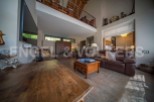 Stunning open-plan living area with high ceilings and a mezzanine level.