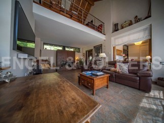 Stunning open-plan living area with high ceilings and a mezzanine level.