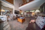 Stunning open-plan living area with high ceilings and large windows offering ample natural light.