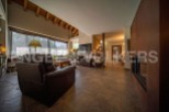 This stunning property boasts a spacious open-plan living area with high ceilings and large windows offering abundant natural light.