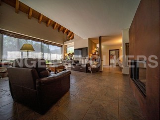 This stunning property boasts a spacious open-plan living area with high ceilings and large windows offering abundant natural light.