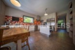 This stunning kitchen boasts a rustic wooden table, modern white cabinetry, and high-end stainless steel appliances.
