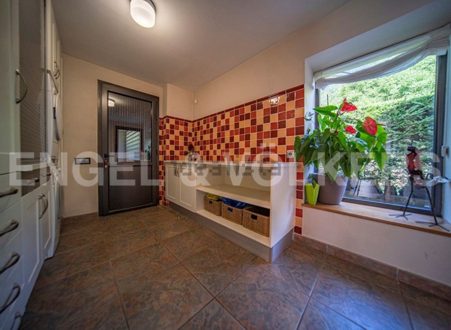 This stunning property boasts a bright and spacious laundry room, complete with modern cabinetry and ample storage.