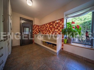 This stunning property boasts a bright and spacious laundry room, complete with modern cabinetry and ample storage.