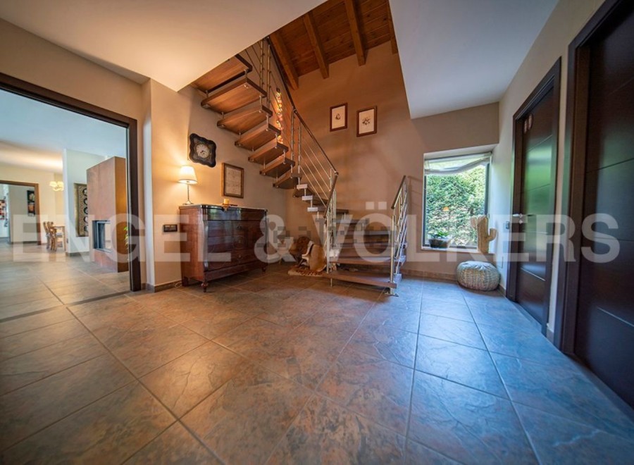 This stunning property boasts a grand entrance hall with a beautiful wooden staircase, creating a welcoming and spacious atmosphere.