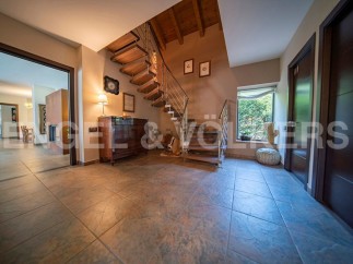 This stunning property boasts a grand entrance hall with a beautiful wooden staircase, creating a welcoming and spacious atmosphere.