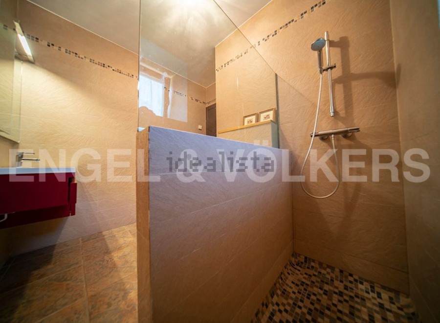 This stunning bathroom boasts a modern, sleek design with a spacious walk-in shower.