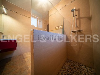 This stunning bathroom boasts a modern, sleek design with a spacious walk-in shower.