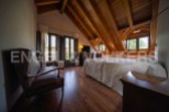 Charming attic bedroom with wooden beams, offering a cozy and rustic atmosphere.