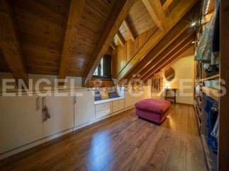 Discover this stunning attic conversion boasting a spacious walk-in closet and built-in storage solutions.
