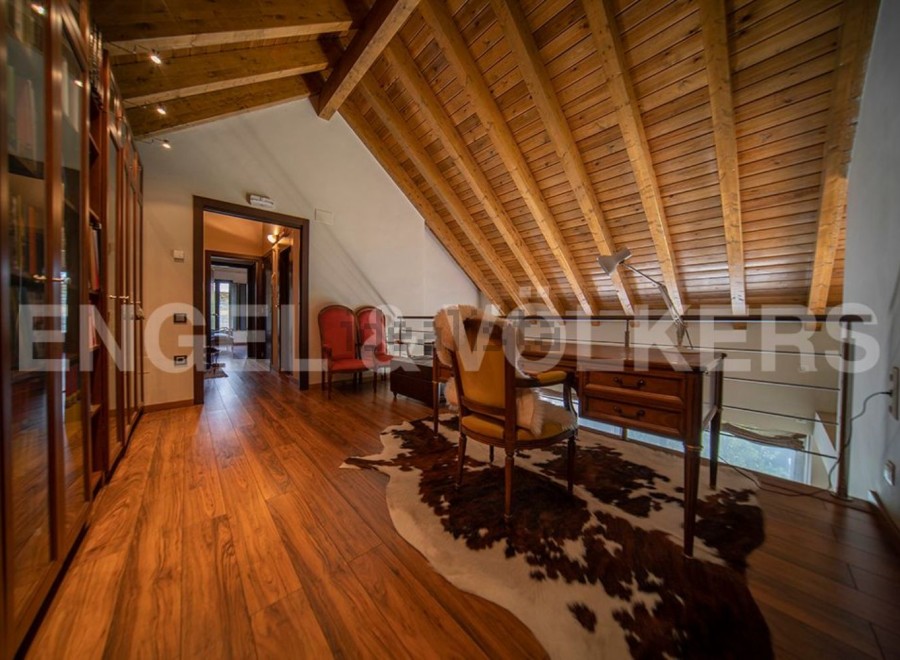 This stunning property boasts a spacious hallway with hardwood floors and built-in wooden cabinetry.