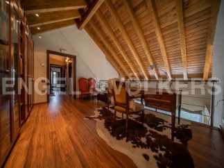 This stunning property boasts a spacious hallway with hardwood floors and built-in wooden cabinetry.