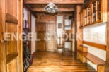 This charming chalet boasts a rustic interior with exposed wooden beams and floors, creating a warm and inviting atmosphere.