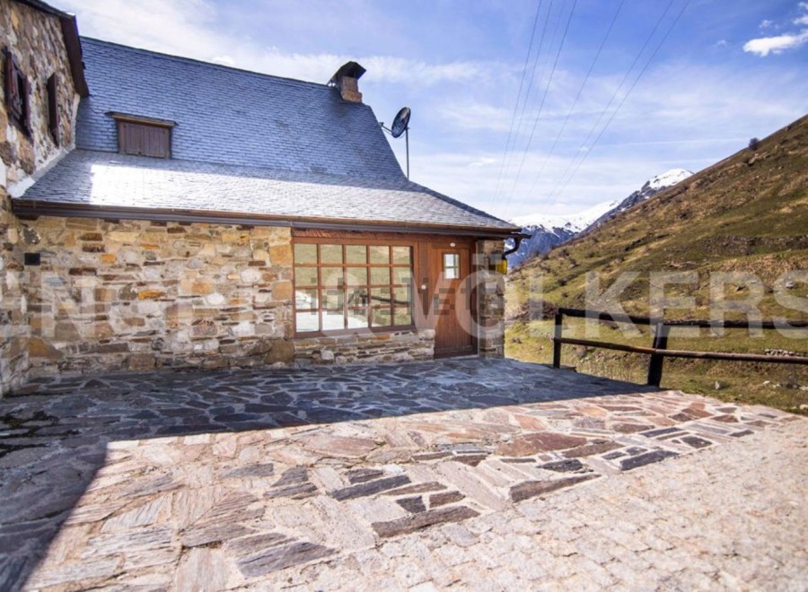 Mountain retreat with stone exterior and patio.