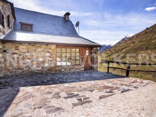 Mountain retreat with stone exterior and patio.