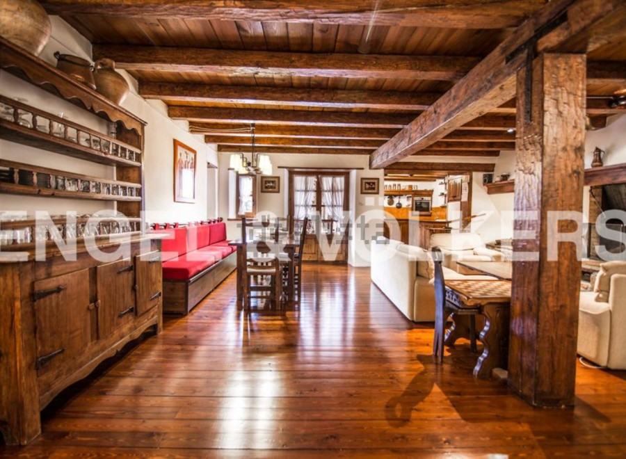 Rustic charm meets modern comfort in this stunning home, featuring exposed wooden beams, hardwood floors, and a cozy fireplace.
