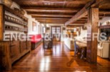 Rustic charm meets modern comfort in this stunning home, featuring exposed wooden beams, hardwood floors, and a cozy fireplace.