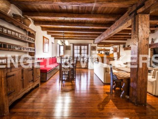 Rustic charm meets modern comfort in this stunning home, featuring exposed wooden beams, hardwood floors, and a cozy fireplace.
