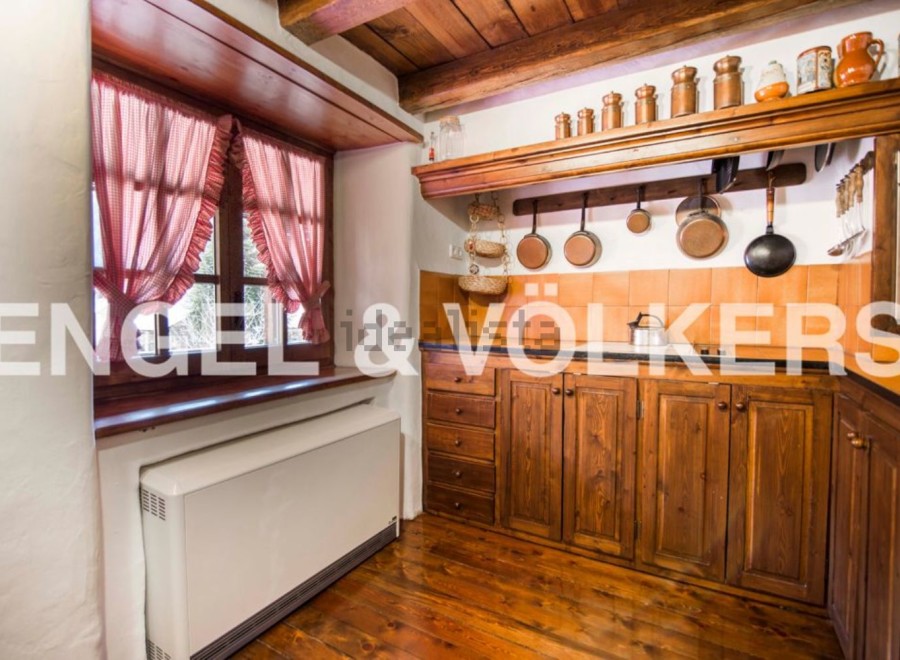 Rustic kitchen with wooden cabinets and copper cookware.