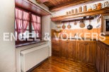Rustic kitchen with wooden cabinets and copper cookware.