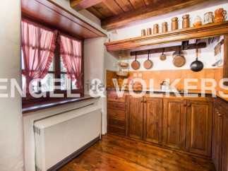 Rustic kitchen with wooden cabinets and copper cookware.
