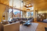 This stunning apartment boasts a spacious living area with floor-to-ceiling windows offering breathtaking mountain views.