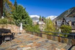 This stunning property boasts a spacious patio with mountain views, perfect for outdoor entertaining.