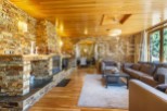 This stunning chalet boasts a spacious living area with a cozy fireplace, perfect for relaxing after a day on the slopes.