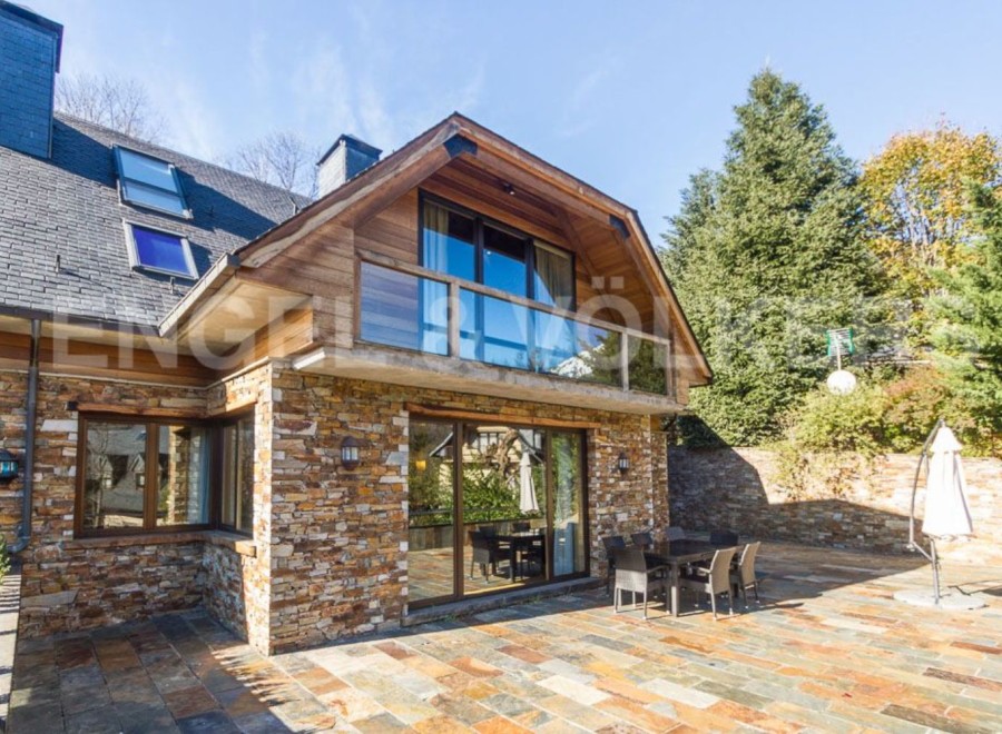 This stunning property boasts a unique blend of rustic charm and modern elegance, featuring a beautiful stone exterior and expansive patio perfect for outdoor entertaining.