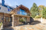 This stunning property boasts a unique blend of rustic charm and modern elegance, featuring a beautiful stone exterior and expansive patio perfect for outdoor entertaining.