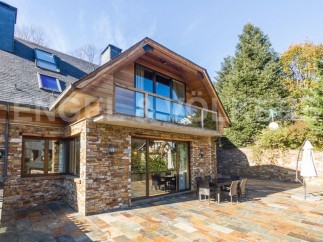 This stunning property boasts a unique blend of rustic charm and modern elegance, featuring a beautiful stone exterior and expansive patio perfect for outdoor entertaining.