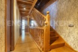 This stunning property boasts a grand wooden staircase, showcasing intricate detailing and craftsmanship.