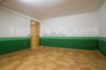 Spacious room with tiled flooring and painted walls.