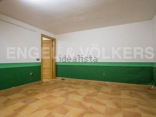 Spacious room with tiled flooring and painted walls.