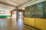 Spacious basement with tiled flooring and ample storage.