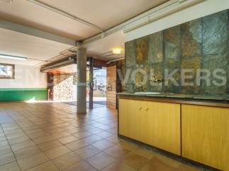 Spacious basement with tiled flooring and ample storage.