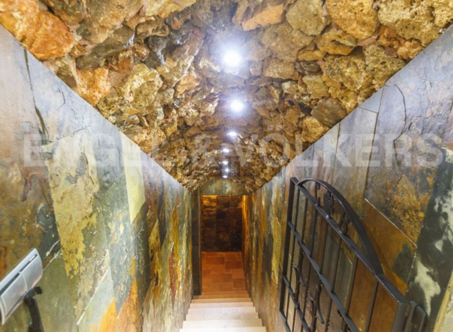 Descend into this unique wine cellar, showcasing a stunning stone and slate design.