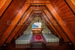 Cozy attic bedroom with twin beds, perfect for a relaxing getaway.