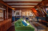 This stunning chalet boasts a spacious open-plan living area with exposed wooden beams, creating a warm and inviting atmosphere.