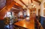 This charming chalet boasts a spacious dining area with a rustic wooden table, perfect for family gatherings.