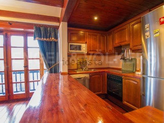 This charming kitchen boasts a rustic wooden design with ample counter space, perfect for cooking and entertaining.