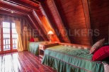 Cozy A-frame cabin with wood-paneled walls and ceilings.
